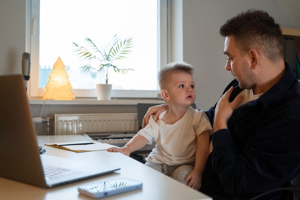 Medium shot father working with kid at home